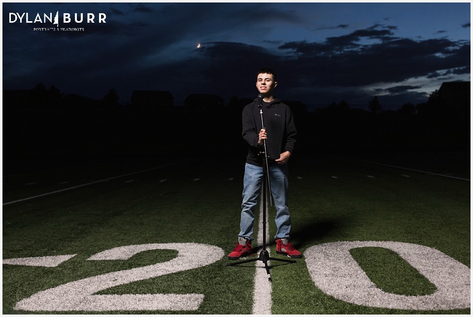 eaglecrest high school senior portraits kaden sports announcer on football field